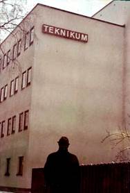 A person standing in front of a building

Description automatically generated with medium confidence