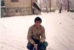 A person sitting in the snow

Description automatically generated